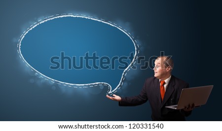 funny businessman in suit holding a laptop and presenting speech bubble copy space