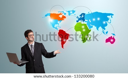 Handsome young man holding a laptop and presenting colorful world map