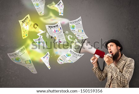 Handsome guy yelling into loudspeaker and newspapers fly out