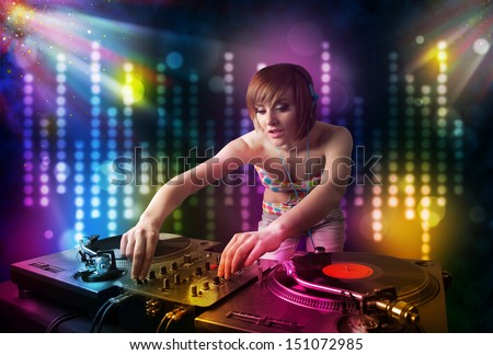 Pretty Dj girl playing songs in a disco with light show