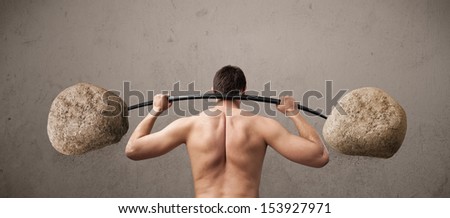 Funny skinny guy lifting large rock stone weights