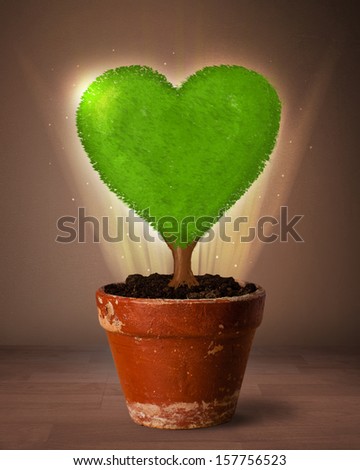 Glowing eco love tree coming out from flowerpot