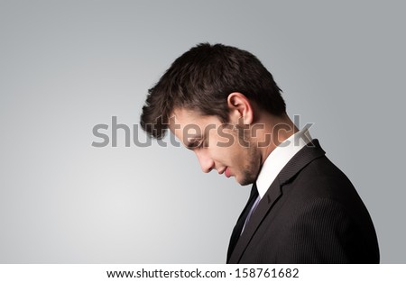 Young businessman thinking with copyspace on color background