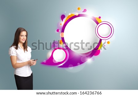 Pretty young woman holding a phone and presenting abstract speech bubble copy space