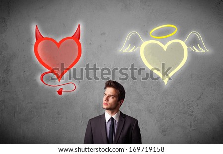 Young businessman standing and choosing between the angel and the devil heart