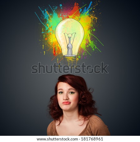 Pretty young woman gesturing with lightbulb and paint splashes above her head