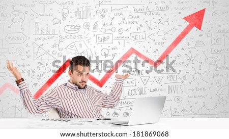 Business man sitting at table with market hand drawn diagrams
