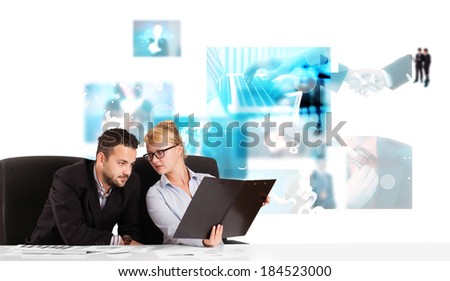 Business persons at desk with modern blue tech images at background