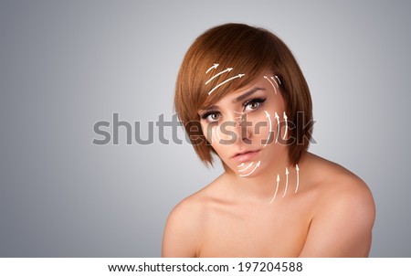 Beautiful girl with facial arrows on her skin on gradient background