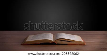 Open book on wooden deck and copy space