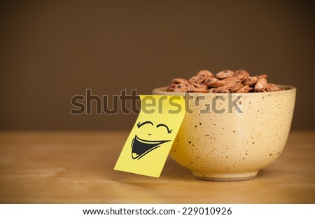 Drawn smiley face on a post-it note sticked on a cereal bowl