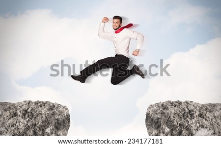 Funny business man jumping over rocks with gap concept