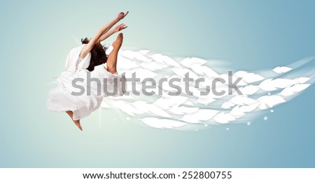 Healthy young woman jumping with feathers around her concept on bright background