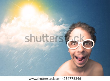 Young person looking with sunglasses at clouds and sun concept on blue background
