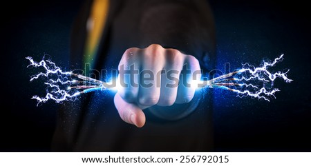 Business person holding electrical powered wires concept on background