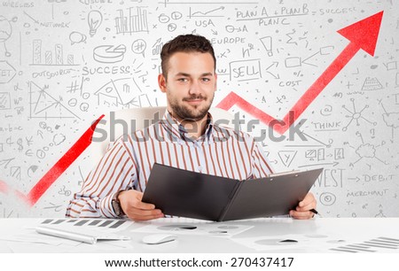 Business man sitting at table with market hand drawn diagrams