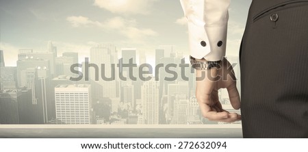 Businessman from the back in front of a city view on the window