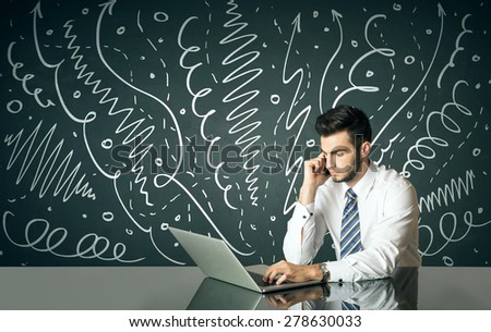 Businessman sitting at table with drawn curly lines and arrows on the background