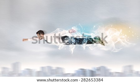 Hero superman flying above city with smoke left behind concept