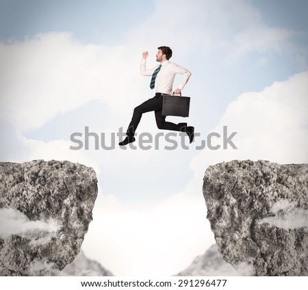 Funny business man jumping over rocks with gap concept