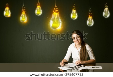 Businesswoman sitting at the black table with idea bulbs on the background