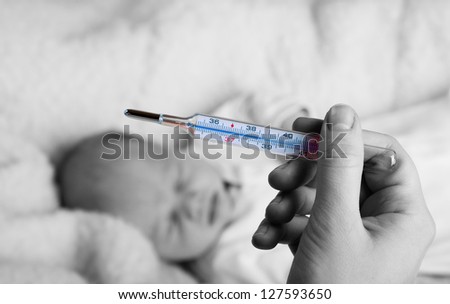 Illness concept, measuring temperature to a baby. Fever