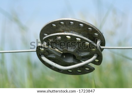 Round metal connector, holds two pieces of wire together so the electric current can pass through. An electic current passes through the wire and give out a small shock to keep the stock in the field