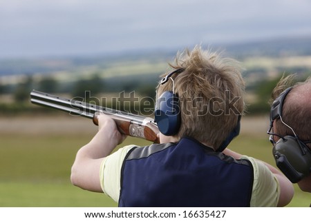 Young boy given advice on  clay pigeon shooting