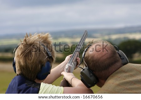 Having tuition the young boy aims the gun