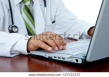 medical doctor at hospital with laptop and stethoscope, shallow