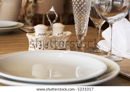 restaurant service table with empty plates and glasses