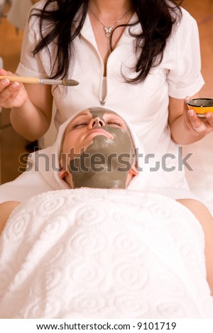 beautiful woman having a face care session at spa center