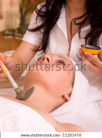 beautiful woman at the spa center for face care session