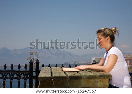 beautiful woman reading a book at the park