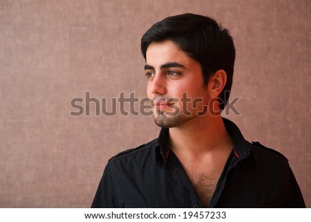 young man portrait close up on grunge wallpaper background