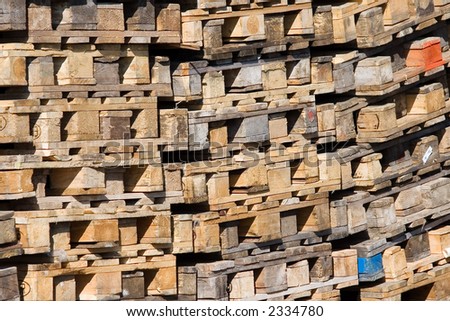 Pile of palettes - recyclable material. Logistics and ecology background.