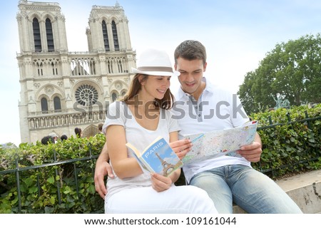 Tourist sitting in front of Notre Dame of Paris Cathedral
