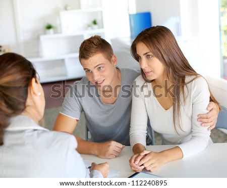 Young couple meeting financial consultant for credit loan