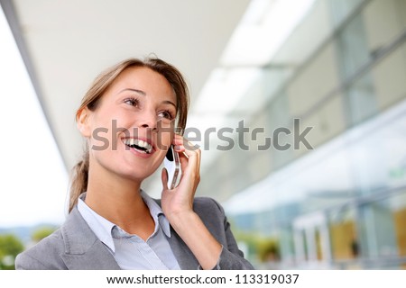 Smiling businesswoman talking on mobile phone