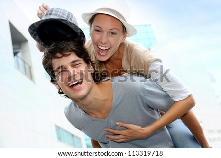 Man giving piggyback ride to girlfriend