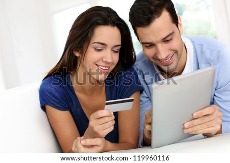 Young couple shopping online from home
