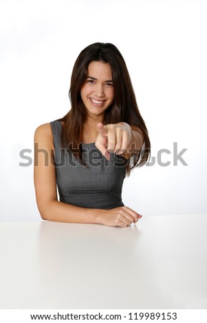 Smiling woman pointing arm towards camera
