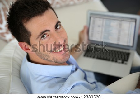 Upper view of young man using laptop computer at home