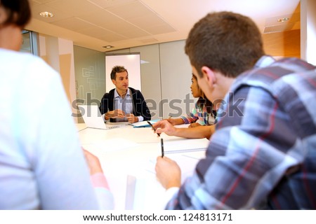 Teacher giving business presentation to students