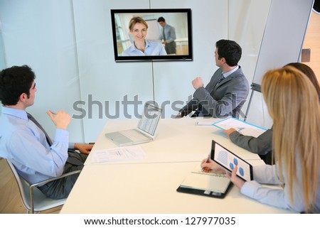 Business people attending videoconference meeting