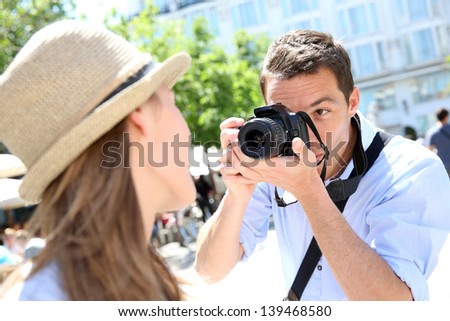 Man taking picture of girlfriend during week-end