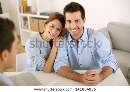 Smiling couple in real-estate agency