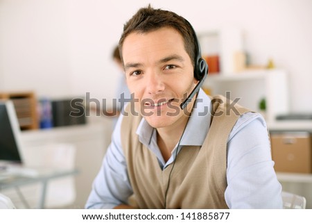 Portrait of consultant on the phone with headset