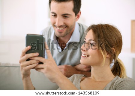 Young people at home using smartphone