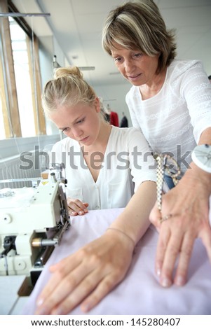 Student with teacher in dressmaking class